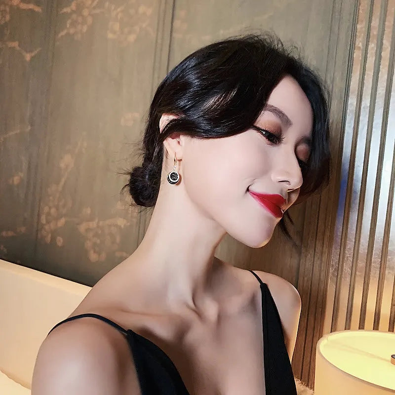 Black geometric alloy earrings with round piece in retro Hong Kong style, 3.6cm long.