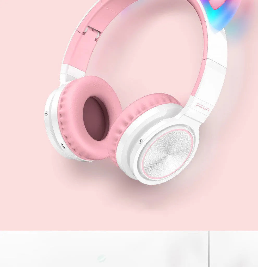 Pink and white wireless Bluetooth over-ear headphones with protein ear cushions and braided charging cable