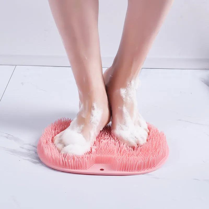 Orange silicone bath brush with suction cups on back and hundreds of small bristles for cleaning feet and back.