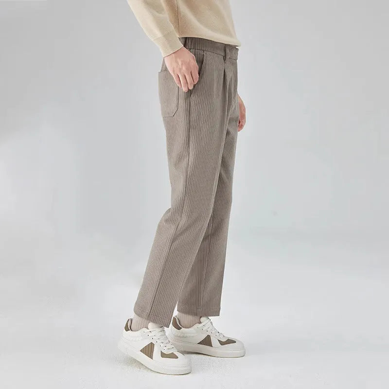 Men's straight-leg loose fit corduroy trousers in beige shown on a model.