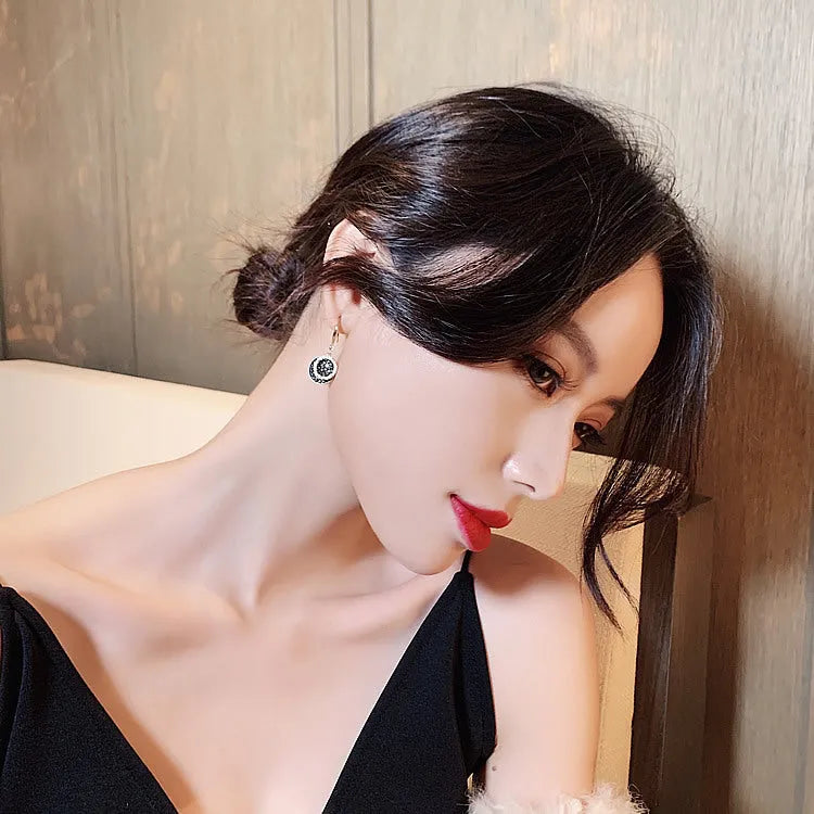 Black geometric alloy earrings with round piece in retro Hong Kong style, 3.6cm long.