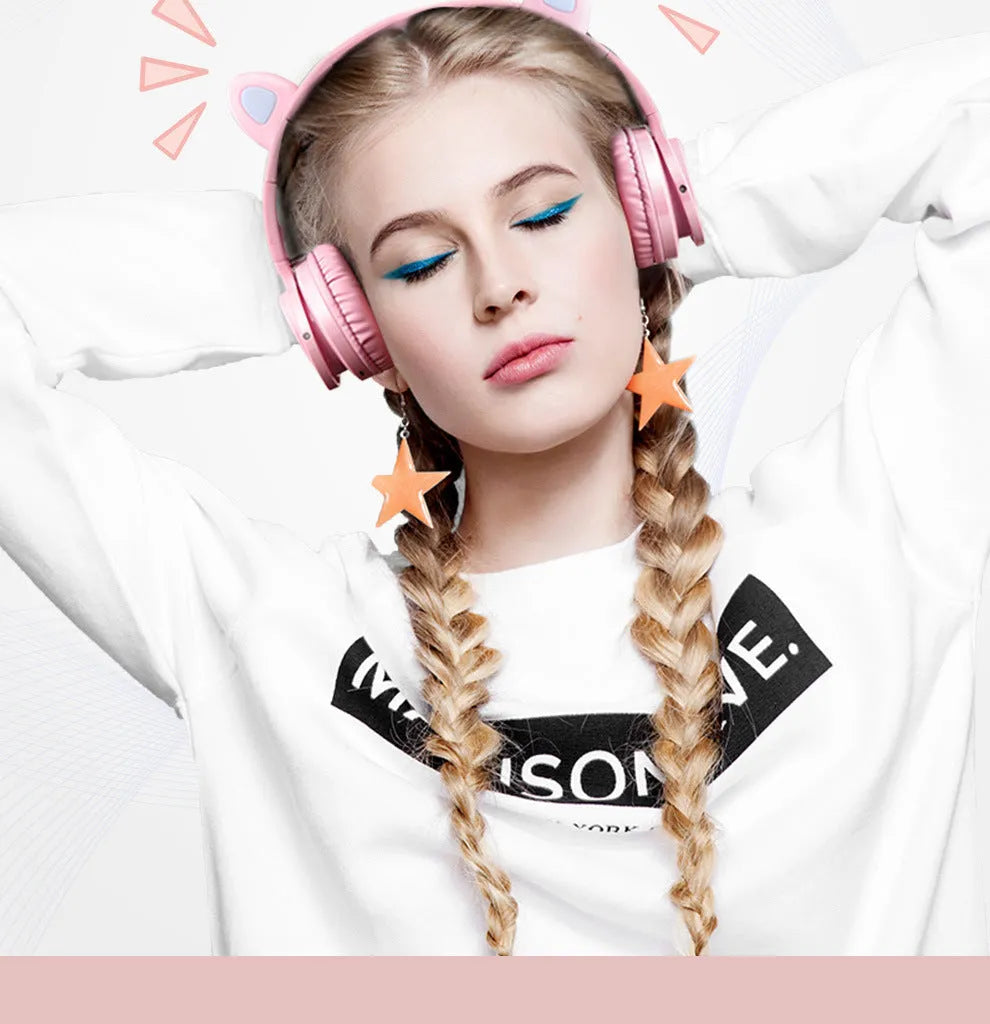 Pink and white wireless Bluetooth over-ear headphones with protein ear cushions and braided charging cable