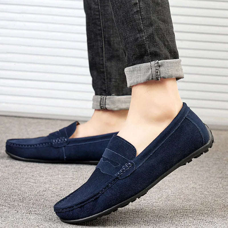 Men's solid colour suede slip-on loafers with a round toe and flat rubber sole.