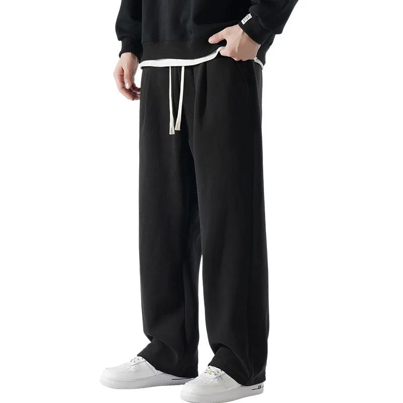 Men's apricot coloured loose-fit polar fleece winter trousers with a drawstring waist, shown flat.