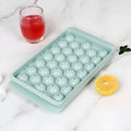 Blue round ice cube tray with 33 moulds and transparent lid