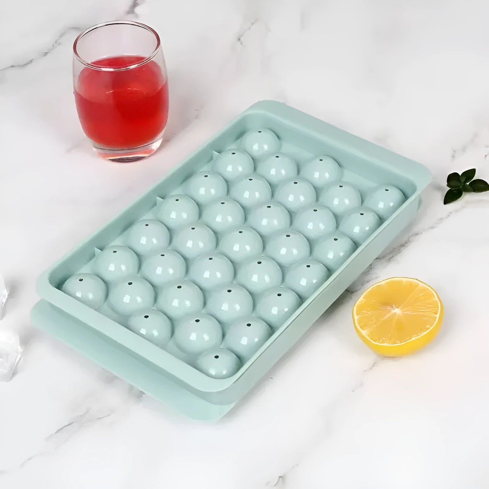 Blue round ice cube tray with 33 moulds and transparent lid