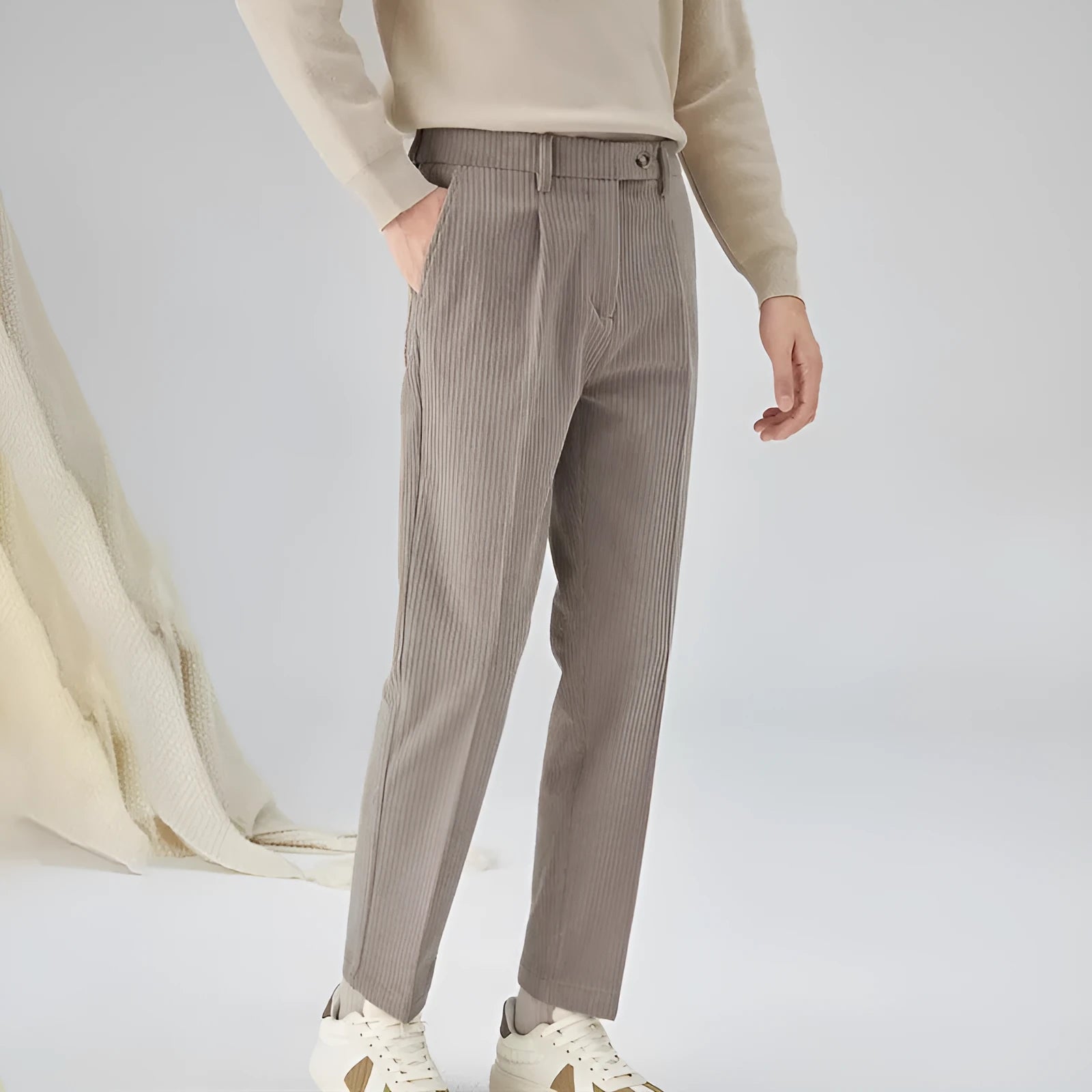 Men's straight-leg loose fit corduroy trousers in beige shown on a model.