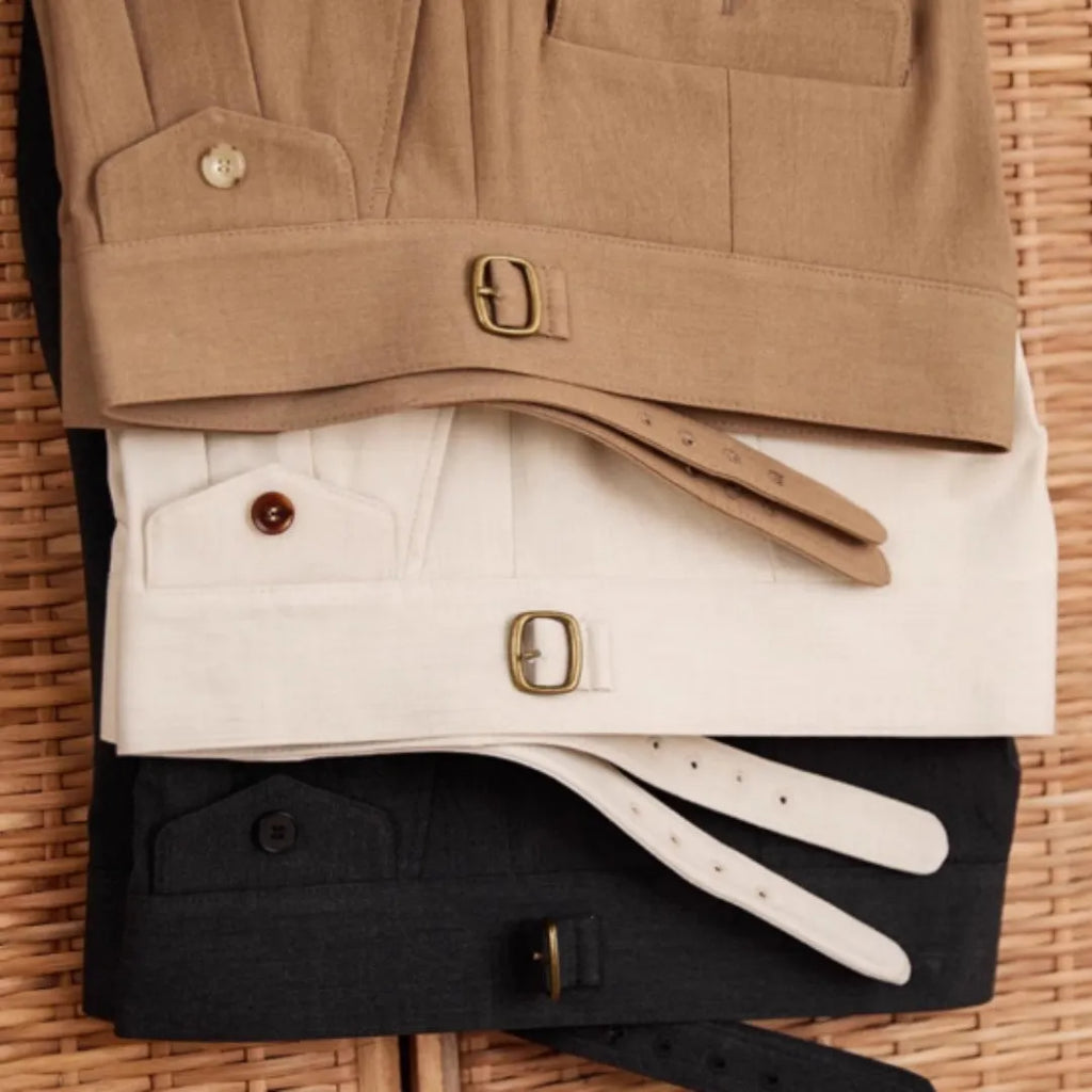 Men's slim fit straight leg trousers in wrinkle-resistant polyester fabric on a hanger.