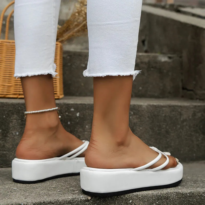 Thick-soled flip-flops in various colours with round toe and herringbone footbed.