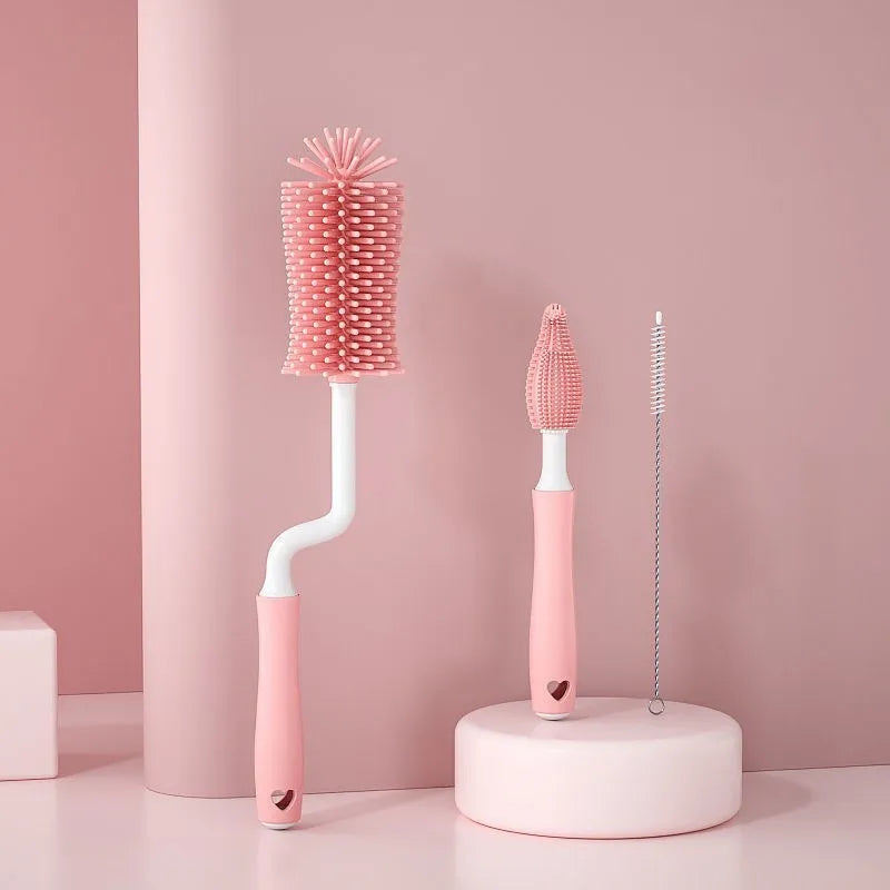 Pink, blue, and yellow silicone baby bottle brush sets with a straw cleaning brush.