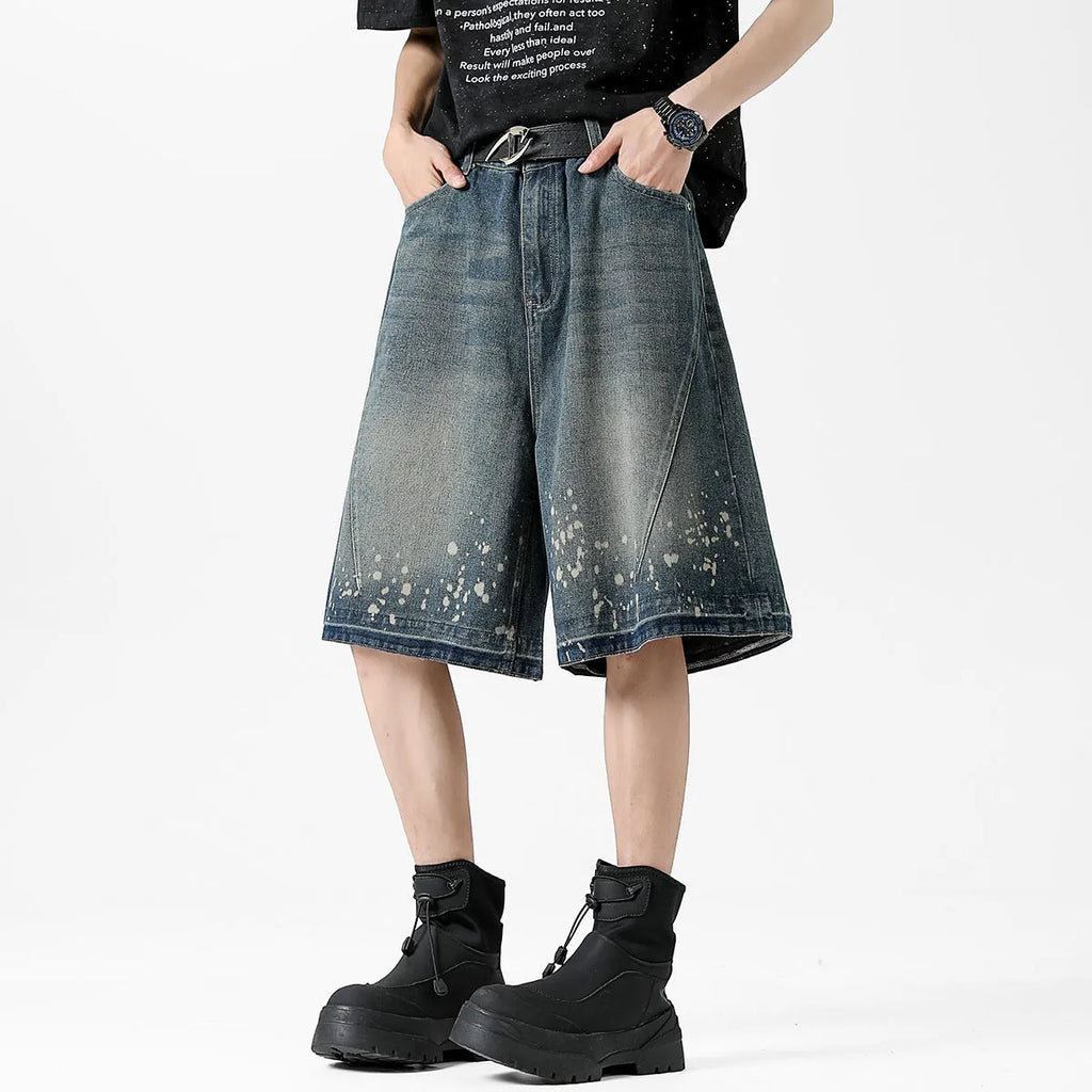 Men's straight cut denim shorts with retro blue wash and ripped splash ink details
