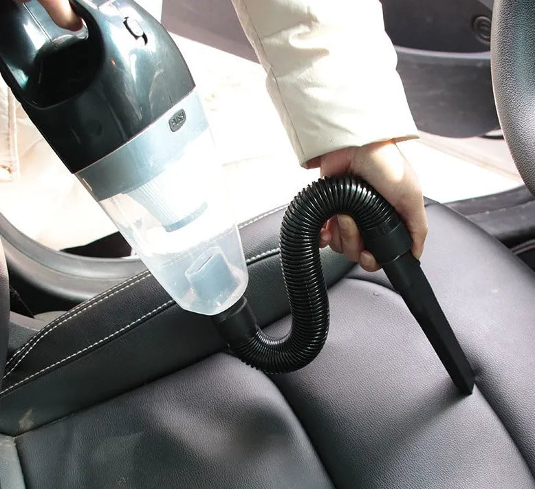 Orange portable handheld car vacuum cleaner with nozzle attachments for 12V vehicle use
