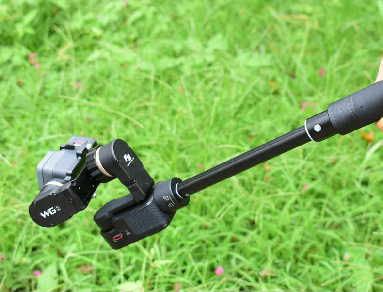 Black retractable selfie stick with integrated stabilizer, shown extended and collapsed