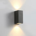 Black aluminium wall lamp with silicone rubber trim and glass elements