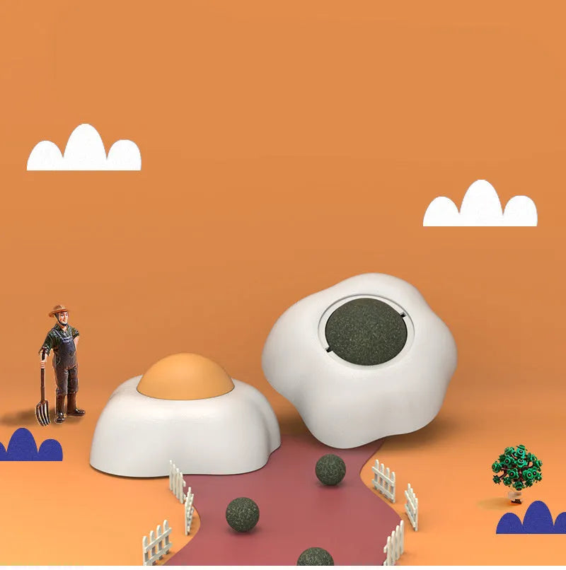 Interactive plush catnip ball toy stuck on a wall, showing Fried Egg and Poached Egg shape options.