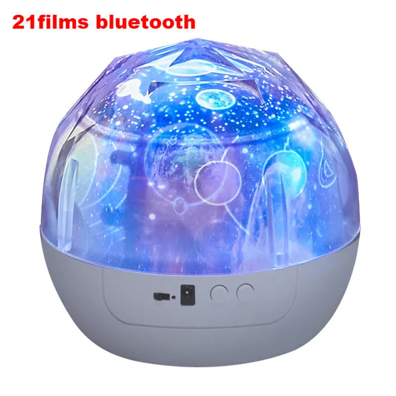 Compact plastic starry sky projection lamp showing cosmos and constellation film options on a table.