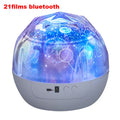 Compact plastic starry sky projection lamp showing cosmos and constellation film options on a table.