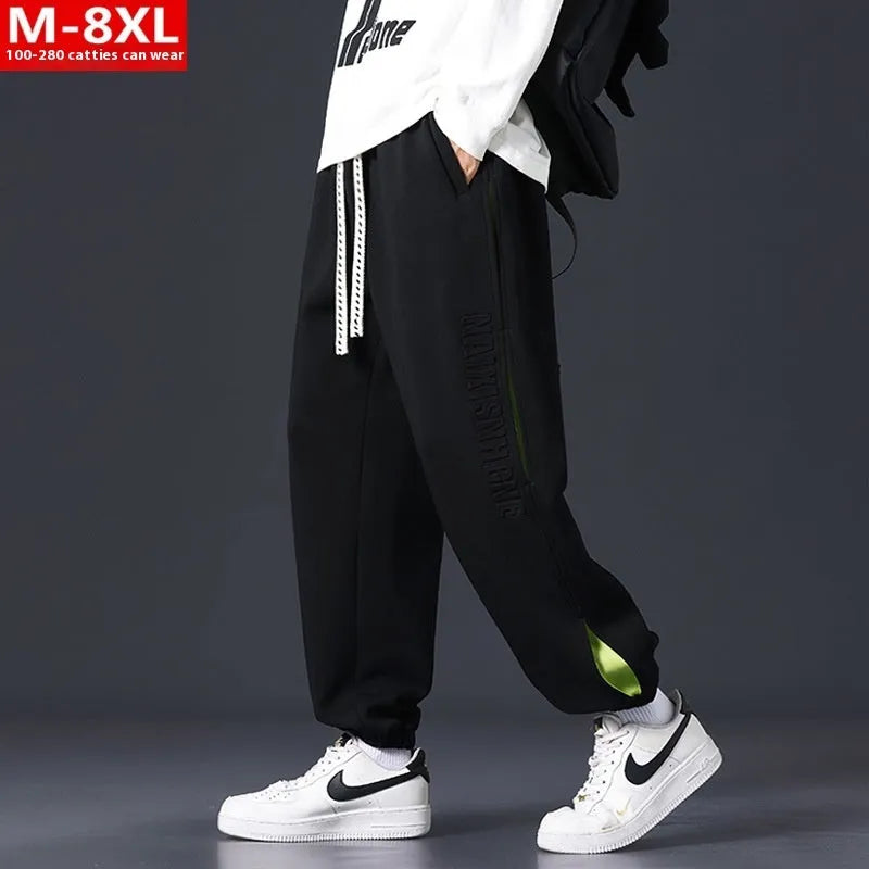 Men's loose-fit cotton trousers with stitching print detail and a banded ankle cuff.