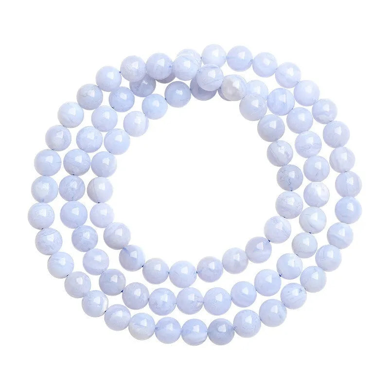 Blue agate beaded bracelet with multi-circle patterns and Ruyi design elements on a wrist.