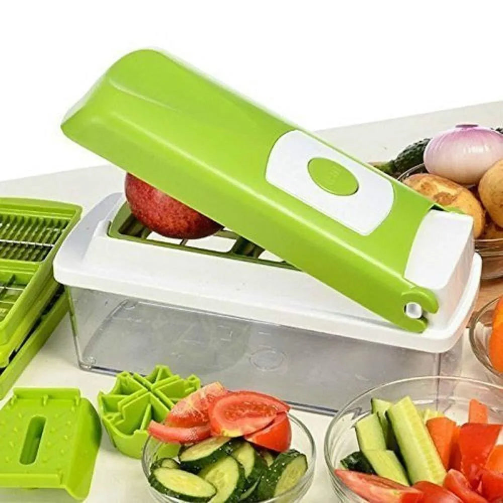 Green manual vegetable chopper with stainless steel blades and multiple cutting accessories on kitchen counter