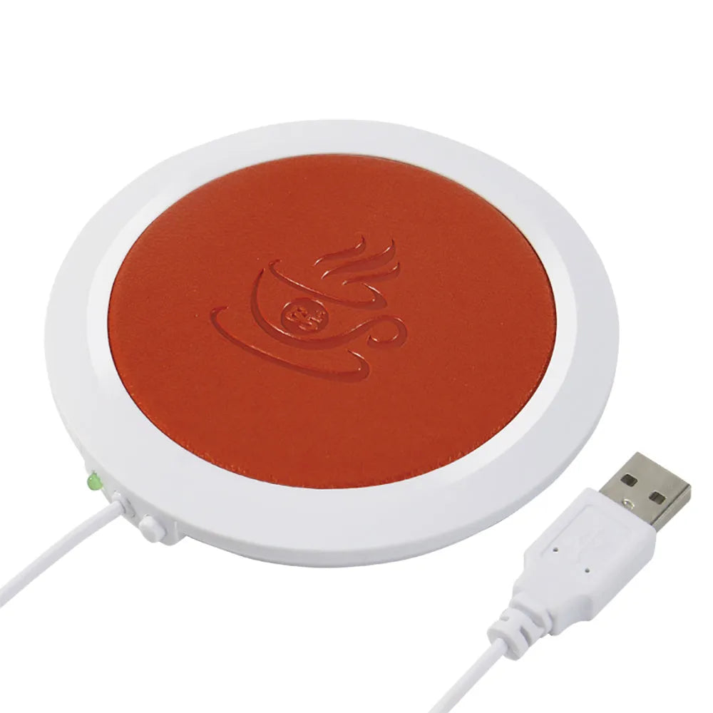 USB-powered insulated heating coaster in black, blue, or orange on a desk.