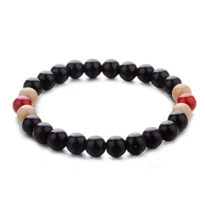 Natural stone beaded bracelet with lava stones on a wrist, showing ethnic style and unisex design.