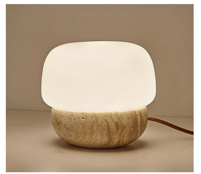 Cream coloured retro ceramic bedside lamp with a globe fabric shade and button switch.
