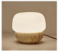 Cream coloured retro ceramic bedside lamp with a globe fabric shade and button switch.