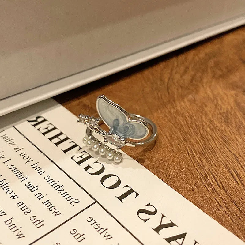 Copper butterfly women's ring with drip oil finish in an open-loop design.