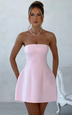 Black backless tube dress with slim fit and short A-line skirt on a model.