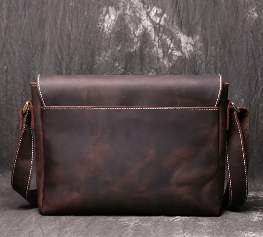 Vintage brown leather mens messenger bag with a flap opening and adjustable shoulder strap.