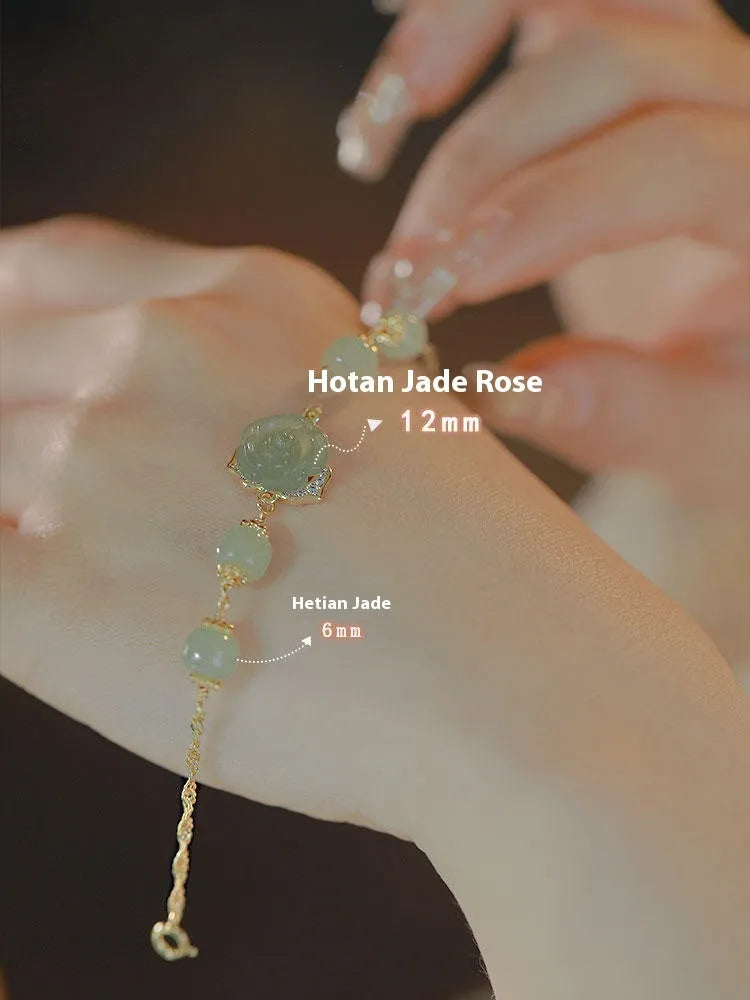 Original design women's bracelet with a Hetian Jade rose and 14K gilded details on a wrist.