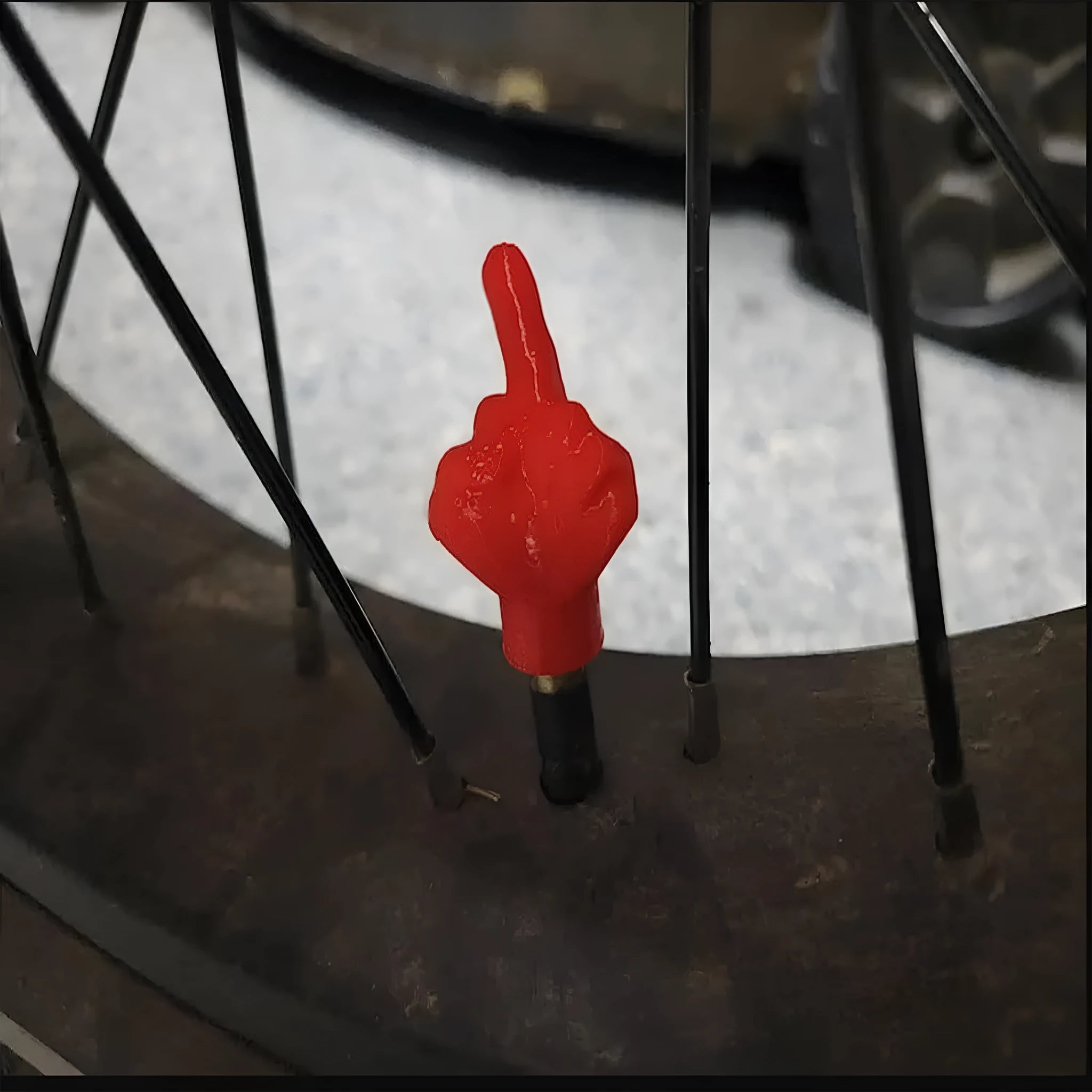 Four latex tyre valve caps, two black and two skin tone, on a grey background