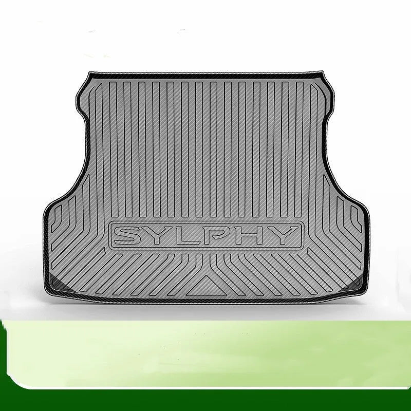 Black TPE car boot liner with carbon fibre pattern texture, shown fitted in a vehicle trunk.
