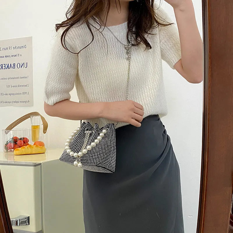 Women's fashion crossbody bag with diamond detailing and chain strap in soft PU material.