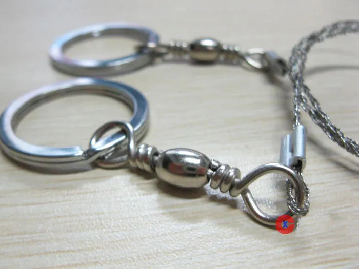 Stainless steel survival wire saw with thumb rings showing 55cm blade and pull ring assembly