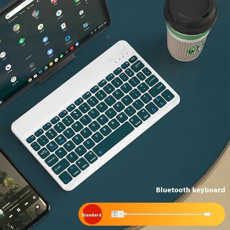 Compact white Bluetooth keyboard for tablet and PC use on a wooden desk