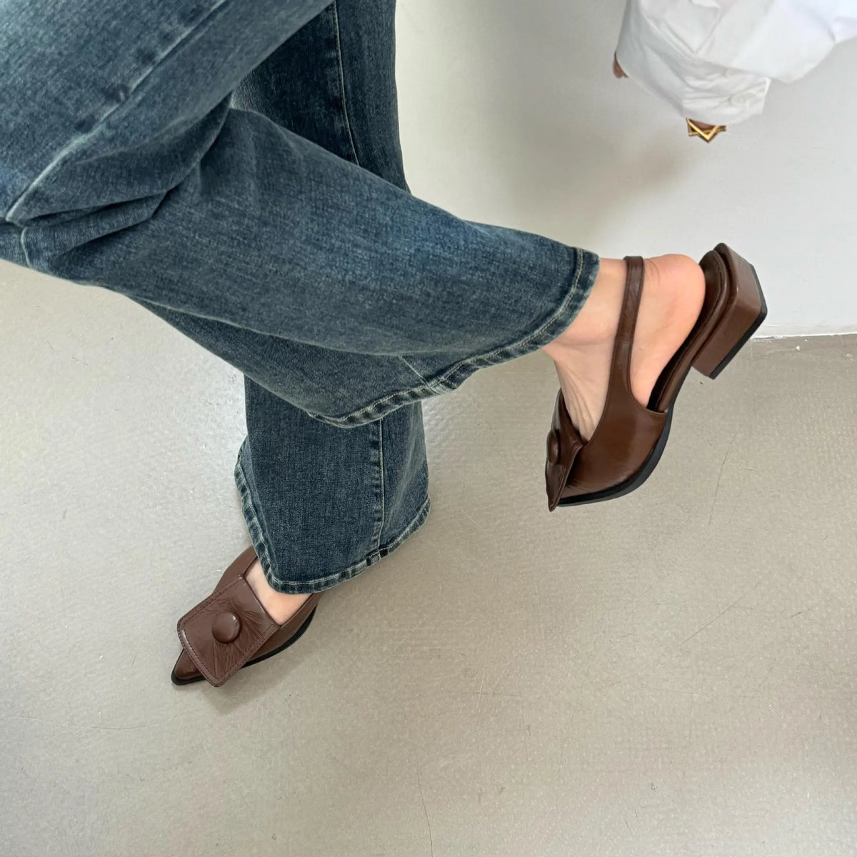 Women's low-heel pointed toe sandals with a back strap in apricot colour on a white background.