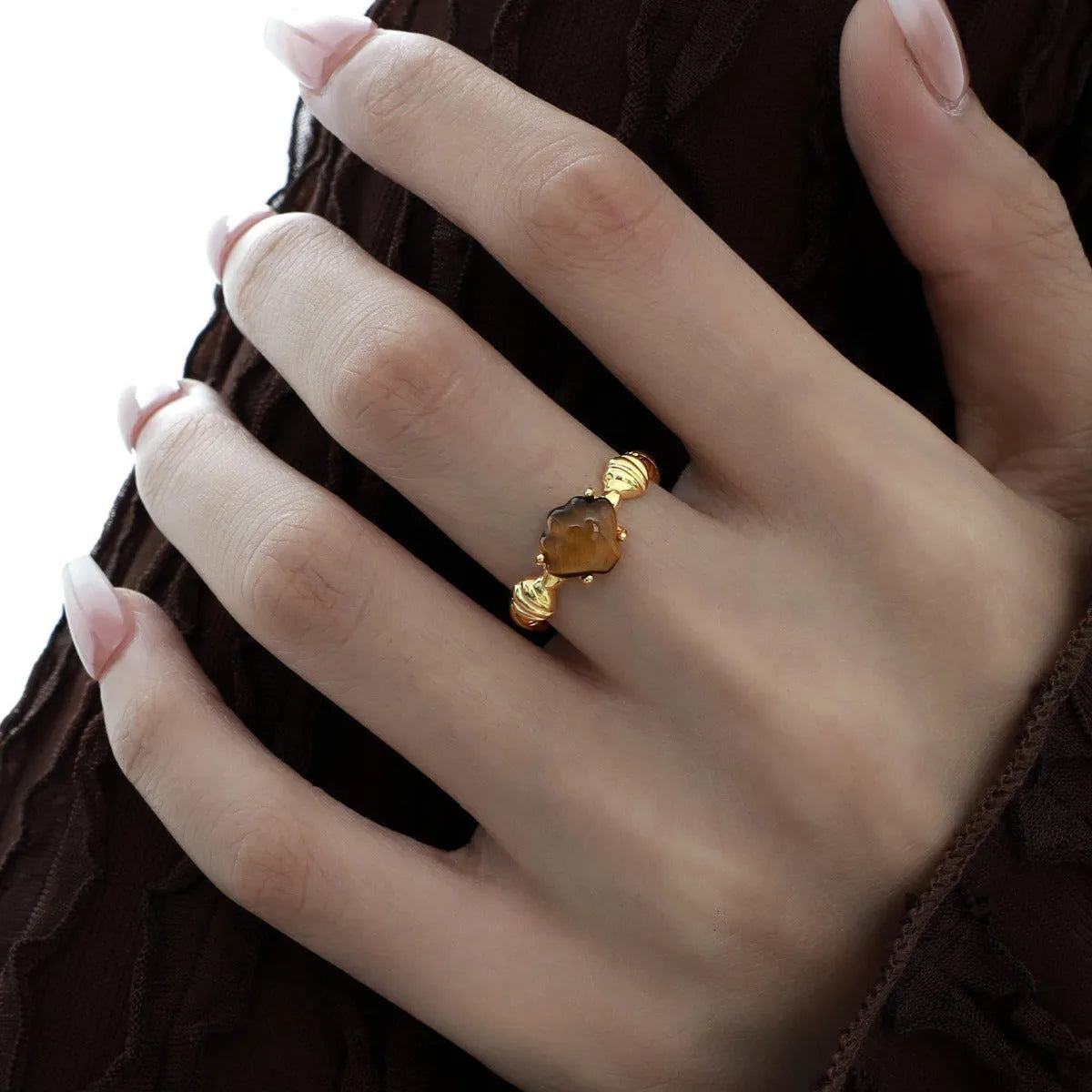 Women's adjustable silver ring featuring a shell and tiger eye stone with an electroplated gold tone finish.