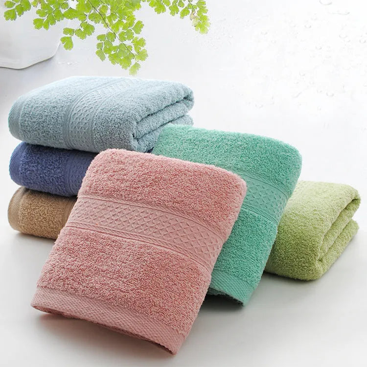 Thickened cotton blend bath and beach towel shown in multiple colour options including green, blue, and pink variations.