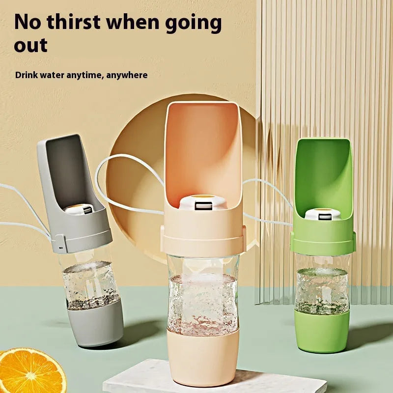 Green 2-in-1 travel dog water bottle and food container with attached lanyard, shown folded.