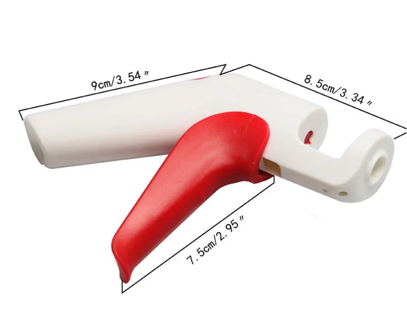 Stainless steel manual cherry kernel remover tool on a kitchen worktop.