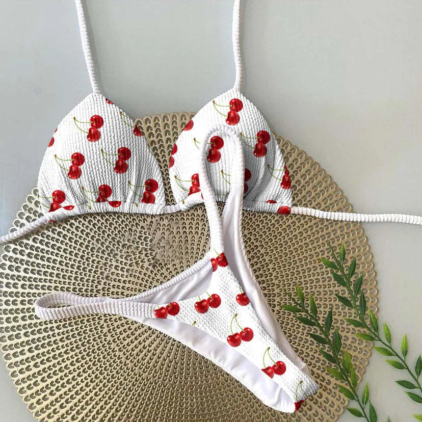 Women's printed bikini swimsuit set on a hanger, showing quick-dry fabric and cotton-lined briefs.