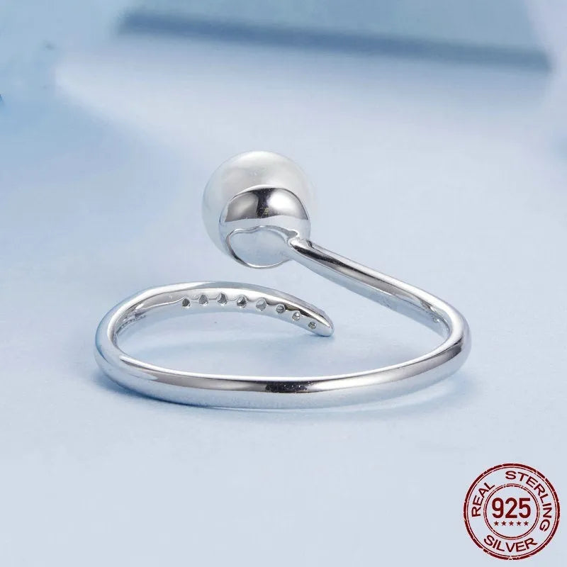 Adjustable S925 sterling silver ring with natural shell pearl elements and open loop design