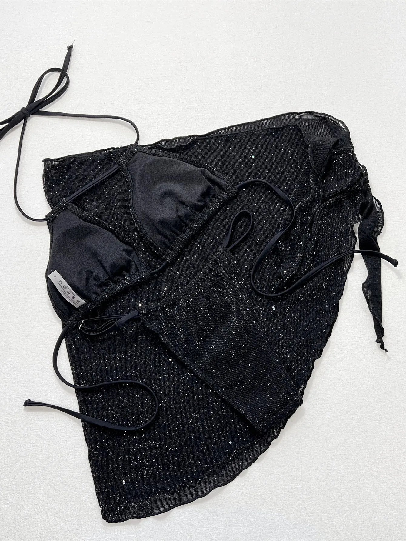 Black three-piece bikini swimsuit set with top and shorts in polyester fibre fabric