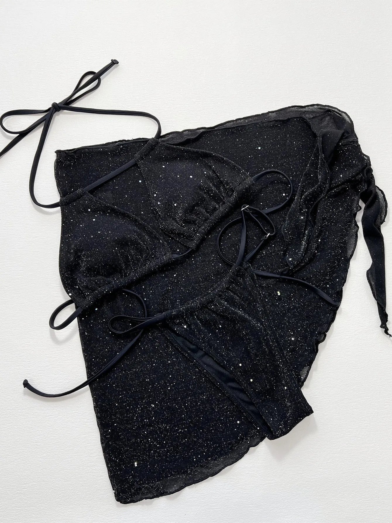 Black three-piece bikini swimsuit set with top and shorts in polyester fibre fabric