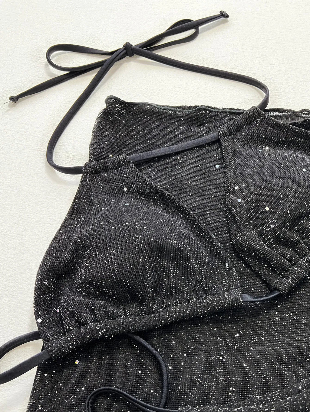 Black three-piece bikini swimsuit set with top and shorts in polyester fibre fabric