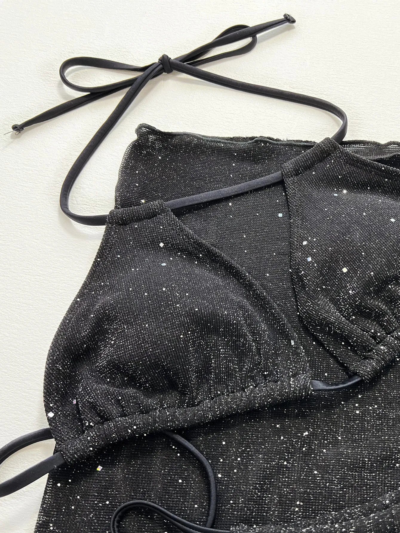 Black three-piece bikini swimsuit set with top and shorts in polyester fibre fabric