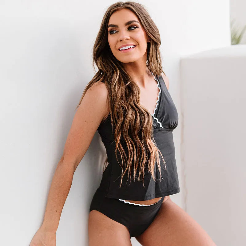 Black women's one-piece split swimsuit made of nylon, shown sleeveless.