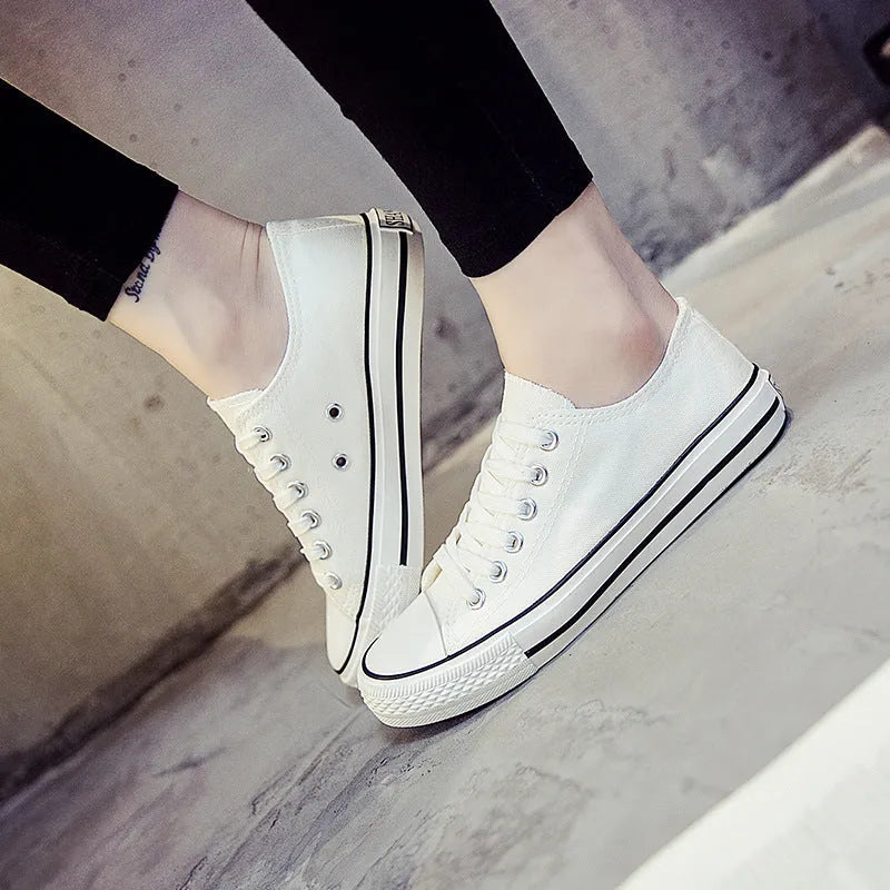 Women's solid colour canvas casual shoes on a plain background, showing the simple design.